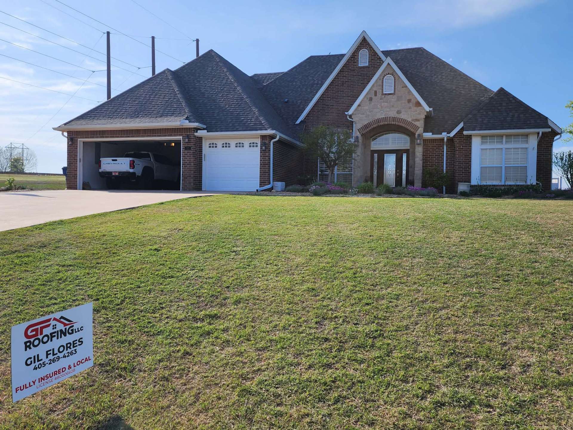 Completed roof replacement with GF Roofing yard sign β Oklahoma home